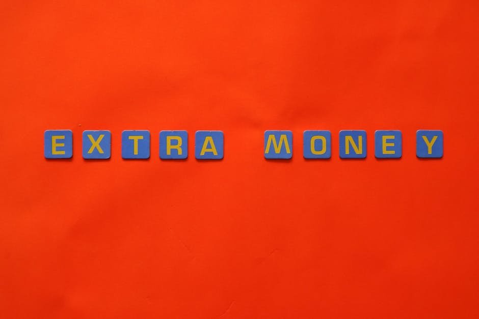 Bright orange background with 'EXTRA MONEY' spelled in blue and yellow tiles, illustrating financial concepts.